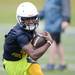 Saline High School's Tyrone Miller carries the ball during a practice drill at the school on Monday, August 12, 2013. Melanie Maxwell | AnnArbor.com